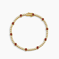 BEZEL-SET ROUND RUBY AND DIAMOND TENNIS BRACELET IN 18K YELLOW GOLD