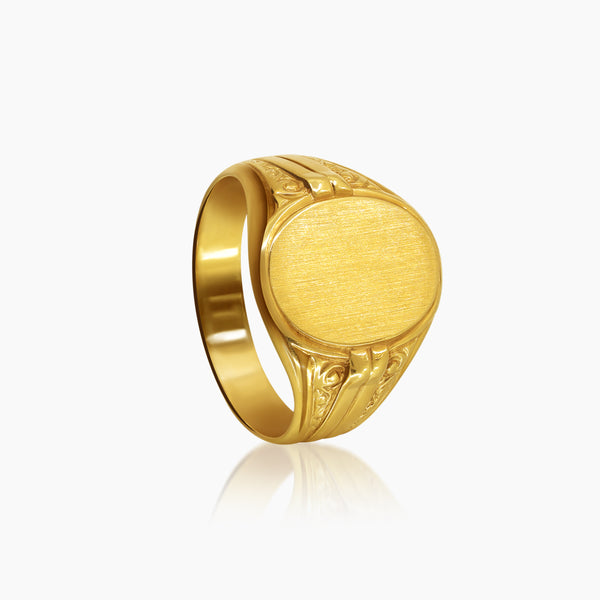 7.5 - OVAL SIGNET MENS RING WITH DECORATED SHOULDERS IN (SAUDI) 18K YELLOW GOLD